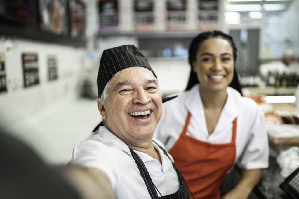 Butchers Taking A Selfie Together In A Butchers Shop