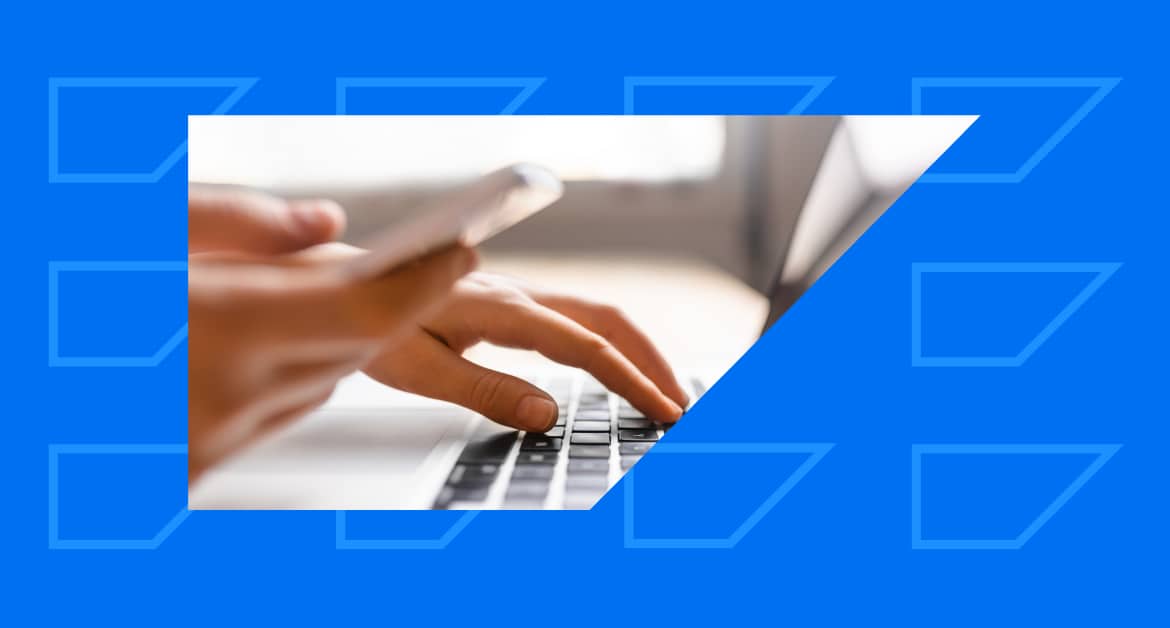 Marketer working with first-party data on laptop and phone.