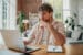Email marketer looking at a laptop screen in a home office.