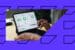 Marketer using a stylus on an ipad to view email marketing metrics.