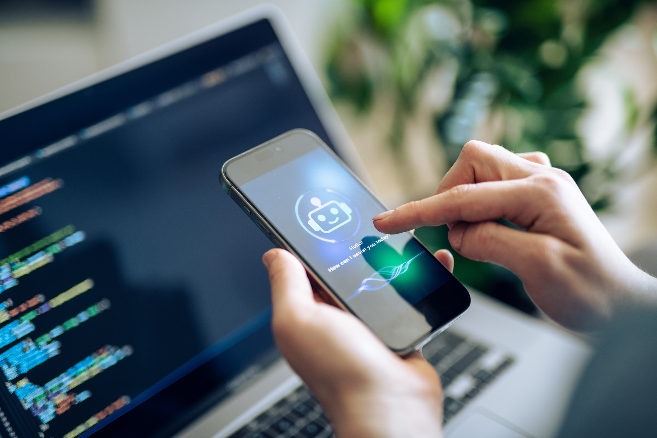 Businesswoman Using Chatting Ai Chatbot Virtual Assistance App On Smartphone To Assist Her While Working On Laptop.