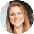 A person is smiling against a blurred indoor background. No text is present.
