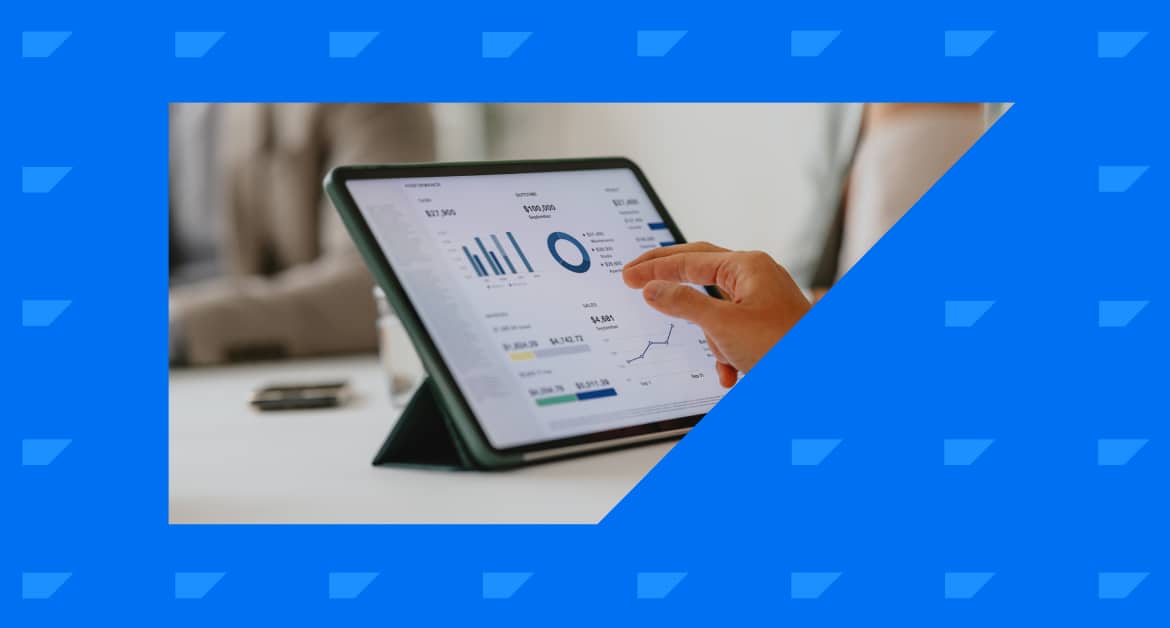 Marketer zooming in on metrics on a tablet dashboard screen.