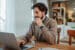 Middle-aged man working from home at a laptop.