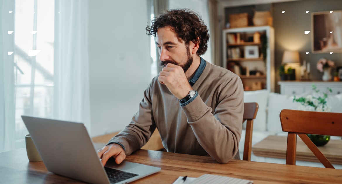 Middle-aged man working from home at a laptop.