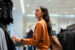 Millennial woman browsing in clothing retail store | Millennial brand loyalty
