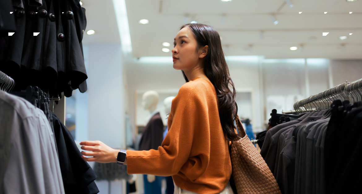Millennial woman browsing in clothing retail store | Millennial brand loyalty
