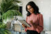 Marketing professional reviewing autonomous marketing campaign data on a tablet in a modern office