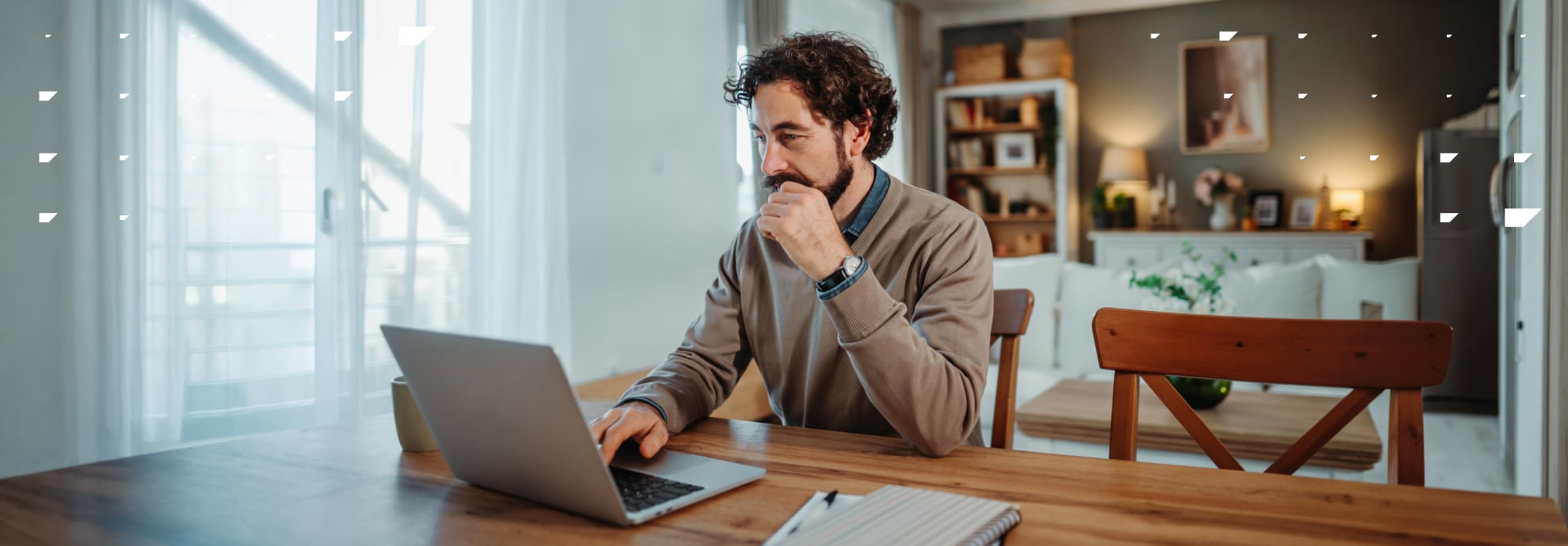 Middle-aged man working from home at a laptop.