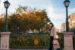 Shopper walking through autumnal street on her phone.