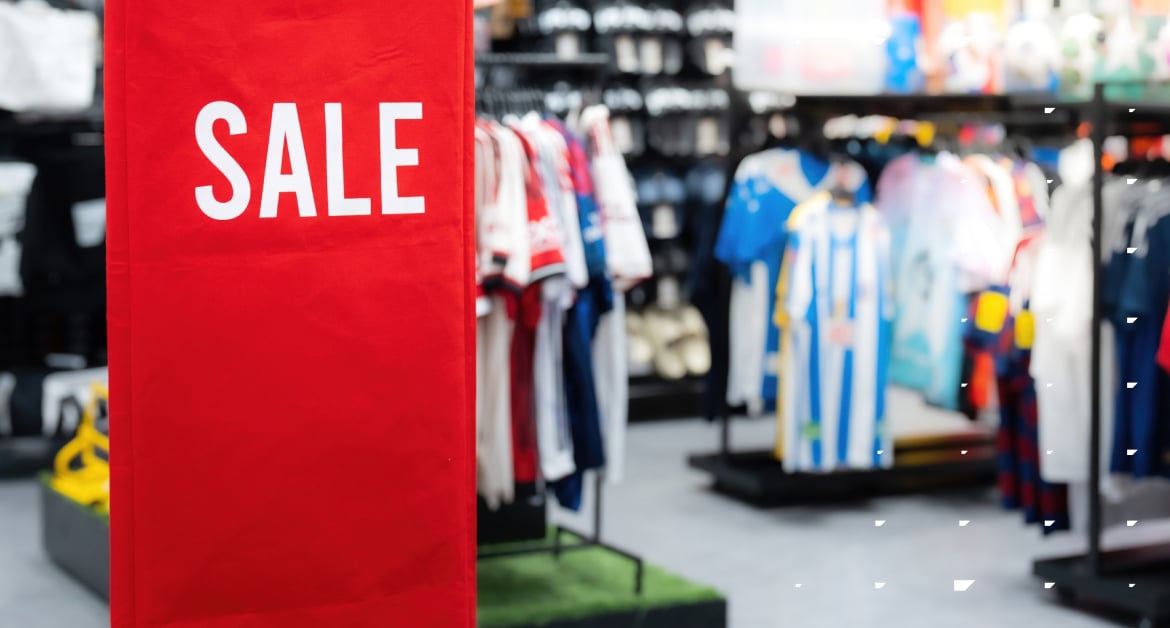 A sports retail store with a sale sign.