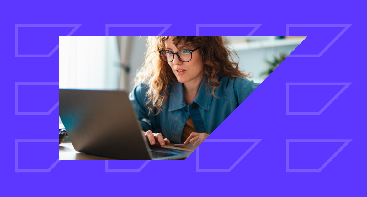 Female marketer looking at customer data on a laptop