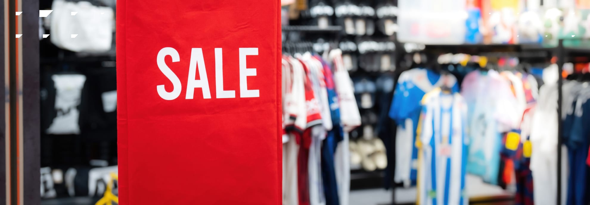 A sports retail store with a sale sign.