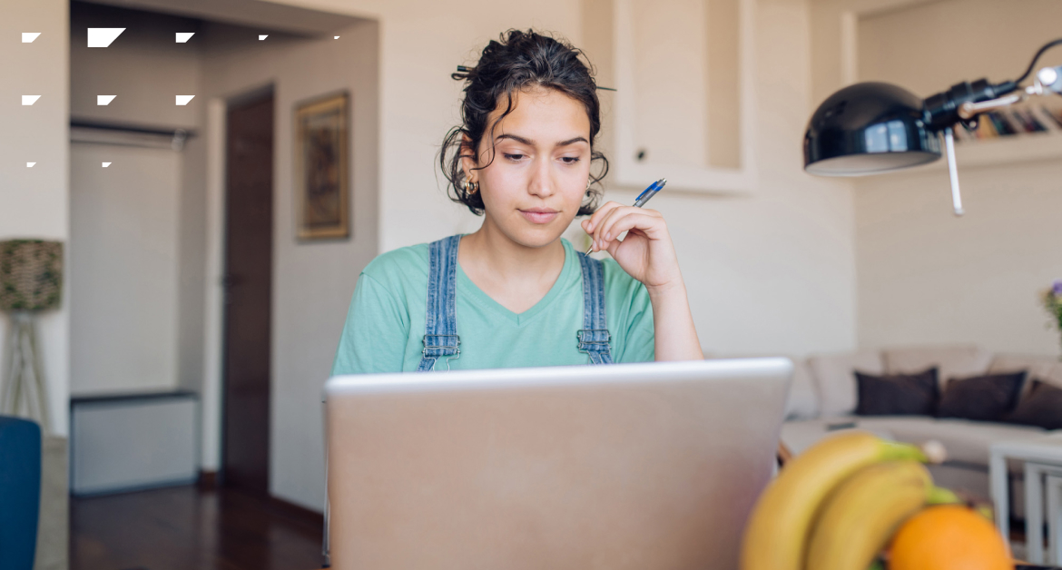 Young woman working or browsing on a laptop in her living room