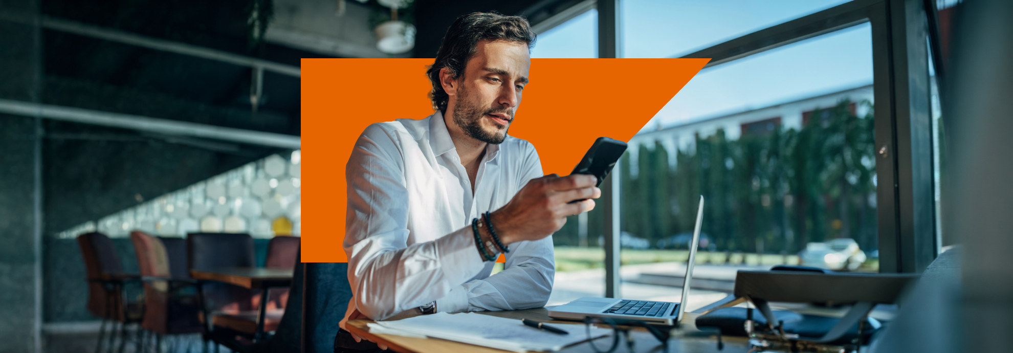 Male marketer checking his mobile at his desk